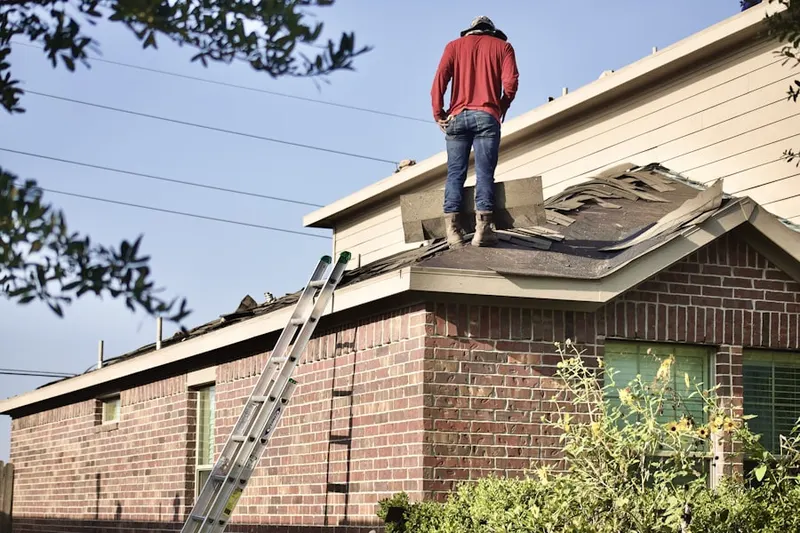 Professional roofer working on a residential roof in Whitpain